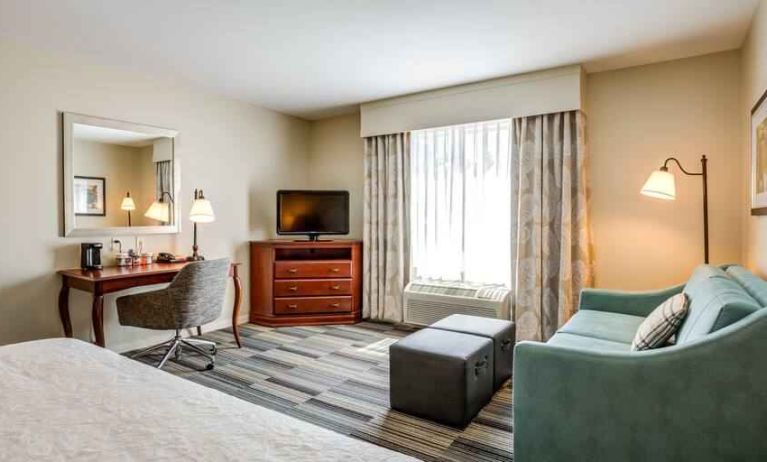 Working station with desk and chair in a hotel room at the Hampton Inn & Suites Westford-Chelmsford.