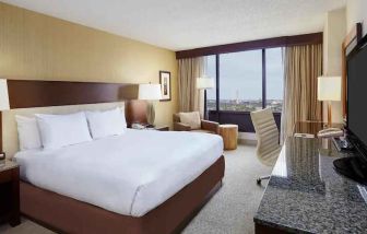 Comfortable king size bed in a hotel guestroom at the DoubleTree by Hilton Washington DC - Crystal City.