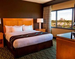 King suite with TV screen and window at the DoubleTree Suites by Hilton Orlando - Disney Springs Area.