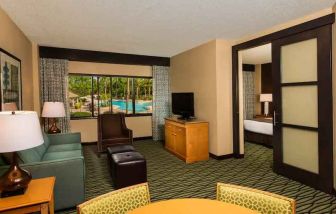 Spacious living room with working station at the DoubleTree Suites by Hilton Orlando - Disney Springs Area.