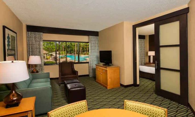 Spacious living room with working station at the DoubleTree Suites by Hilton Orlando - Disney Springs Area.