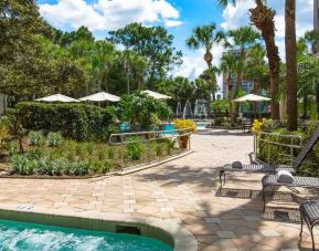 Beautiful outdoor patio with plants by the pool at the DoubleTree Suites by Hilton Orlando - Disney Springs Area.