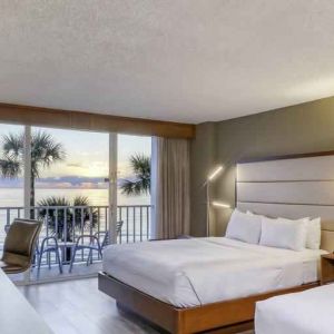 Double queen bedroom with view and balcony at the DoubleTree Beach Resort by Hilton Tampa Bay - North Redingto.