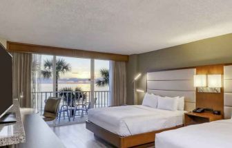 Double queen bedroom with view and balcony at the DoubleTree Beach Resort by Hilton Tampa Bay - North Redingto.