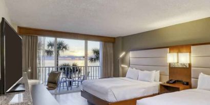 Double queen bedroom with view and balcony at the DoubleTree Beach Resort by Hilton Tampa Bay - North Redingto.