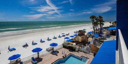 Beautiful outdoor space with pool along the hotel beach at the DoubleTree Beach Resort by Hilton Tampa Bay - North Redingto.