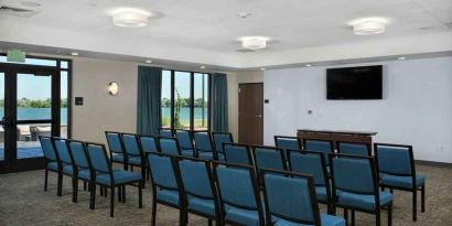 Meeting room with tables and screen at the Hampton Inn Burley.