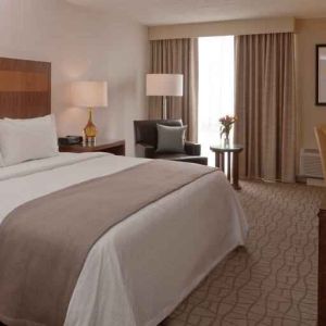 King guestroom with desk and TV screen at the DoubleTree by Hilton Pittsburgh Green Tree.