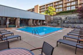 Outdoor pool with lounges at the DoubleTree by Hilton Pittsburgh Green Tree.