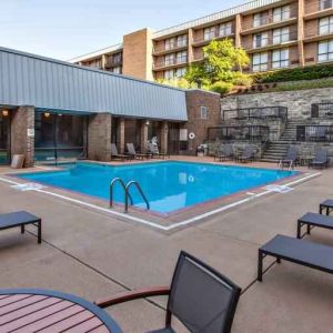 Outdoor pool with lounges at the DoubleTree by Hilton Pittsburgh Green Tree.