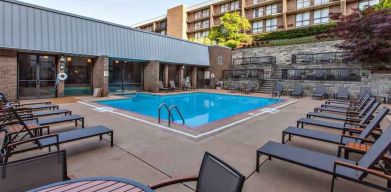 Outdoor pool with lounges at the DoubleTree by Hilton Pittsburgh Green Tree.