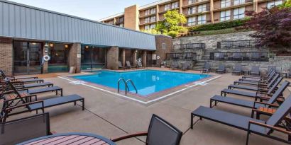 Outdoor pool with lounges at the DoubleTree by Hilton Pittsburgh Green Tree.