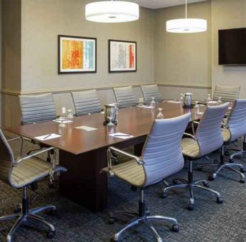 Small meeting room with TV screen at the DoubleTree by Hilton Pittsburgh Green Tree.