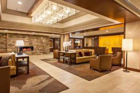 Elegant lobby workspace with sofas and fireplace at the DoubleTree by Hilton Pittsburgh Green Tree.