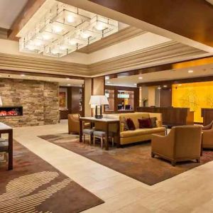 Elegant lobby workspace with sofas and fireplace at the DoubleTree by Hilton Pittsburgh Green Tree.