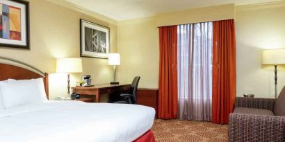 Desk and sofa in a king bedroom at the DoubleTree by Hilton Grand Rapids Airport.