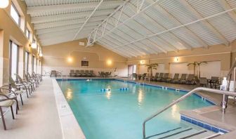 Indoor pool with lounges at the DoubleTree by Hilton Grand Rapids Airport.