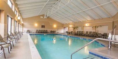 Indoor pool with lounges at the DoubleTree by Hilton Grand Rapids Airport.