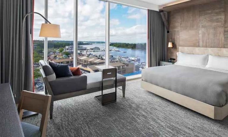 Bright king bedroom with lounge overlooking the water at the Canopy by Hilton Washington DC The Wharf.