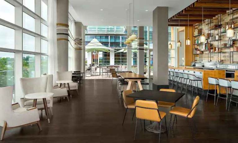 Lobby workspace with tables and chairs at the Canopy by Hilton Washington DC The Wharf.