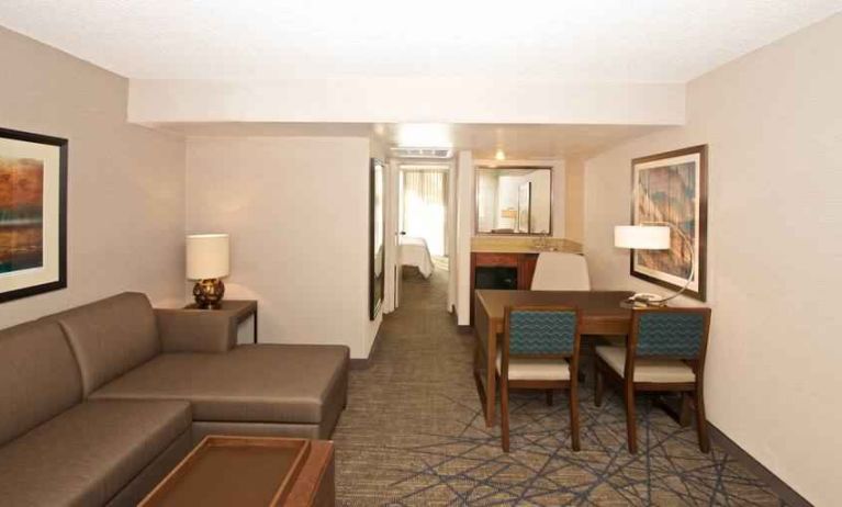 Living room with working station in a hotel room at the Embassy Suites by Hilton Colorado Springs.