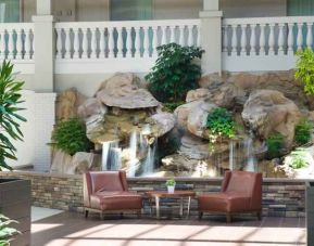 Beautiful outdoor patio with waterfall perfect for co-working at the Embassy Suites by Hilton Colorado Springs.
