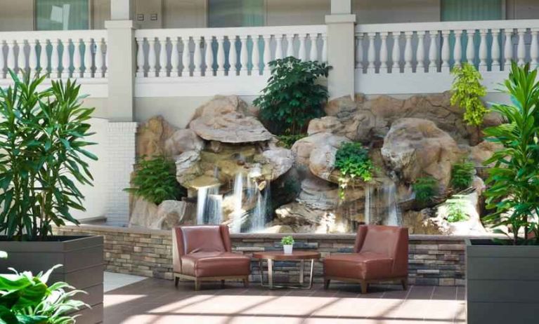 Beautiful outdoor patio with waterfall perfect for co-working at the Embassy Suites by Hilton Colorado Springs.