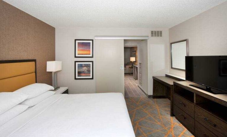 Comfortable bedroom in a king suite at the Embassy Suites by Hilton Cincinnati Blue Ash.