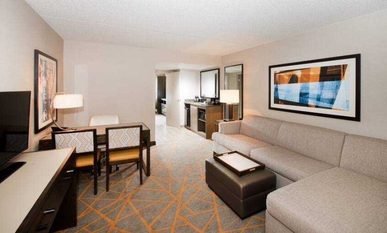 Living room with working station in a hotel suite at the Embassy Suites by Hilton Cincinnati Blue Ash.