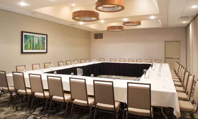 Meeting room with square conference table at the Embassy Suites by Hilton Cincinnati Blue Ash.