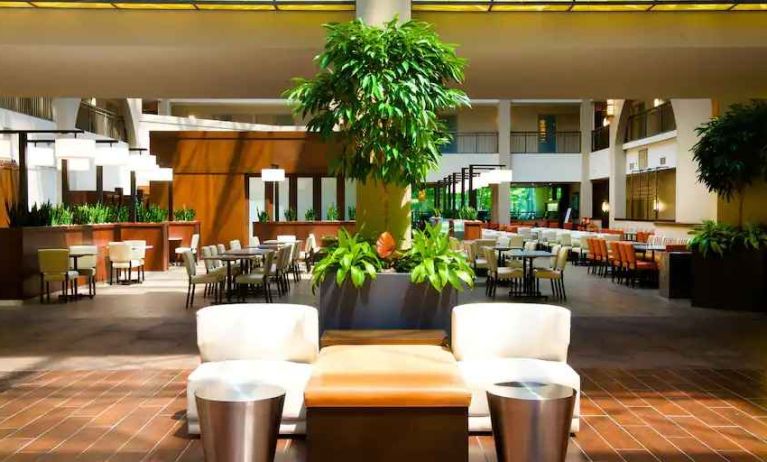 Elegant lobby workspace with plants at the Embassy Suites by Hilton Cincinnati Blue Ash.