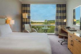 King guestroom with desk and TV screen at the Hilton Reading.