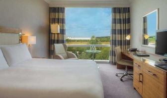 King guestroom with desk and TV screen at the Hilton Reading.