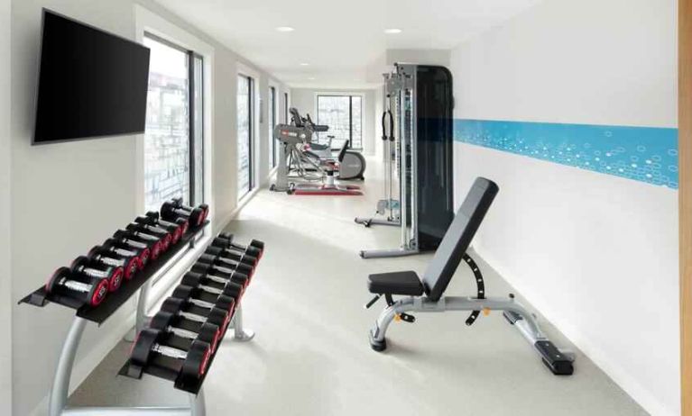 Bright fitness room with weights at the Hampton by Hilton London Docklands.