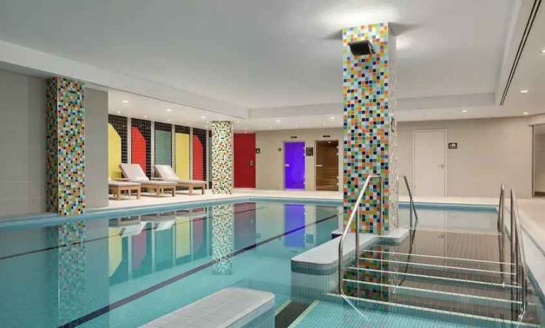 Indoor pool with lounges at the Hilton London Wembley.