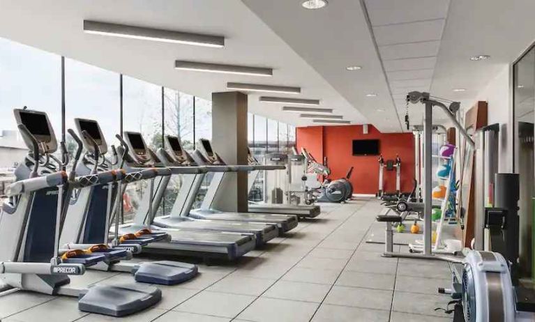 Treadmills in a bright fitness center at the Hilton London Wembley.