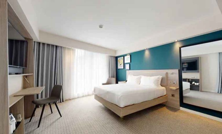 Bright and spacious king suite with working station at the Hampton by Hilton Manchester Northern Quarter.