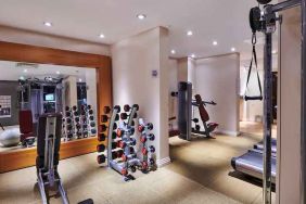 Fitness center with weights and mirror at the DoubleTree by Hilton London - Ealing.