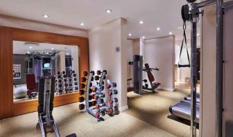 Fitness center with weights and mirror at the DoubleTree by Hilton London - Ealing.