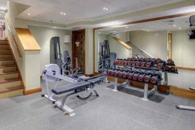 Fitness center with weights at the Hilton London Paddington.