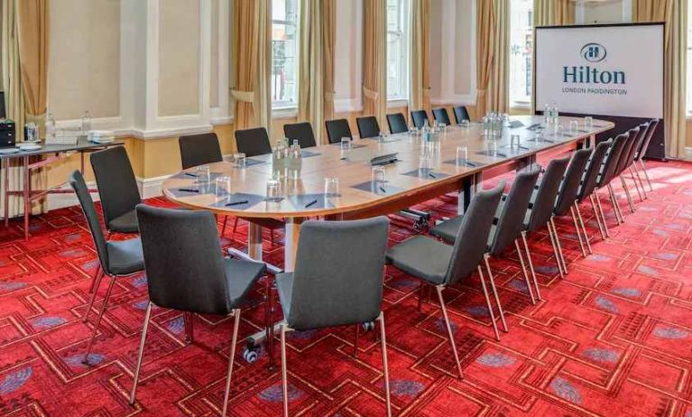 Meeting room with large screen at the Hilton London Paddington.