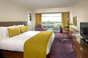 spacious king suite with work area and TV at Hilton London Metropole.