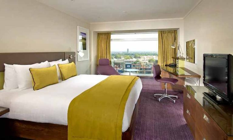 spacious king suite with work area and TV at Hilton London Metropole.