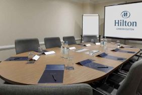 Meeting room with screen and blackboard at the Hilton London Euston.