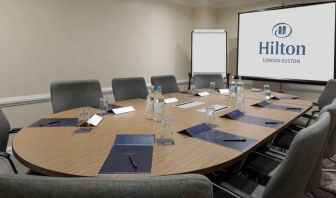 Meeting room with screen and blackboard at the Hilton London Euston.