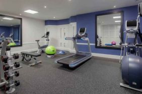 Fitness center with weights and machines at the Hilton London Euston.