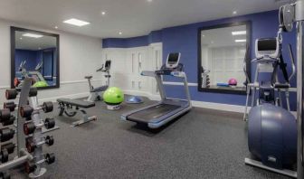 Fitness center with weights and machines at the Hilton London Euston.