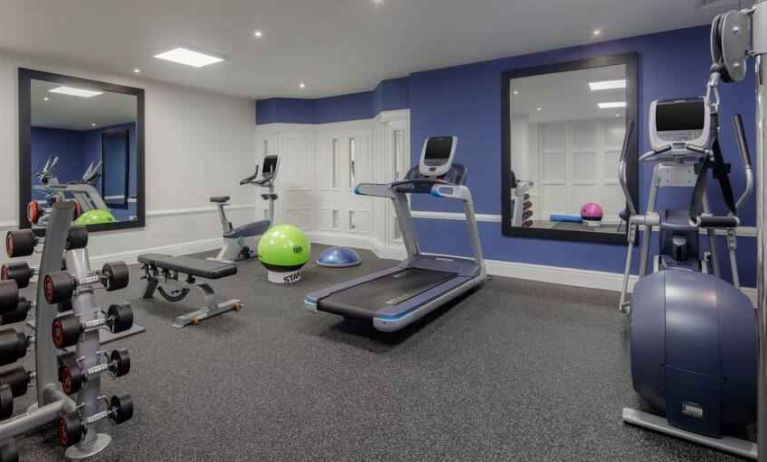 Fitness center with weights and machines at the Hilton London Euston.