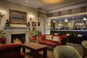 Elegant lobby workspace by the fireplace at the Hilton London Euston.