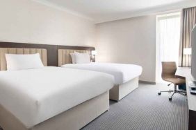 Double guest room with TV screen and desk at the Hilton London Gatwick Airport.